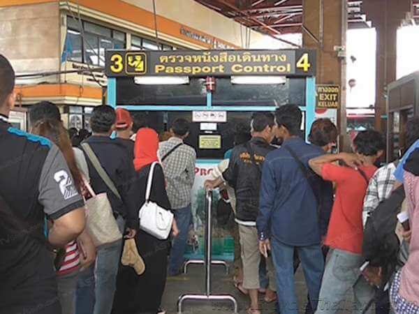 Thailand immigration kiosks. The entry/departure card table where you must pay 2 Ringgit is off to the left of these kiosks.