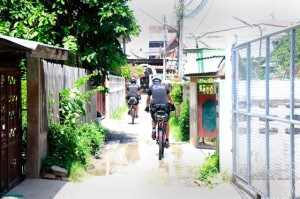 Ayutthaya police on bicycles in small soi